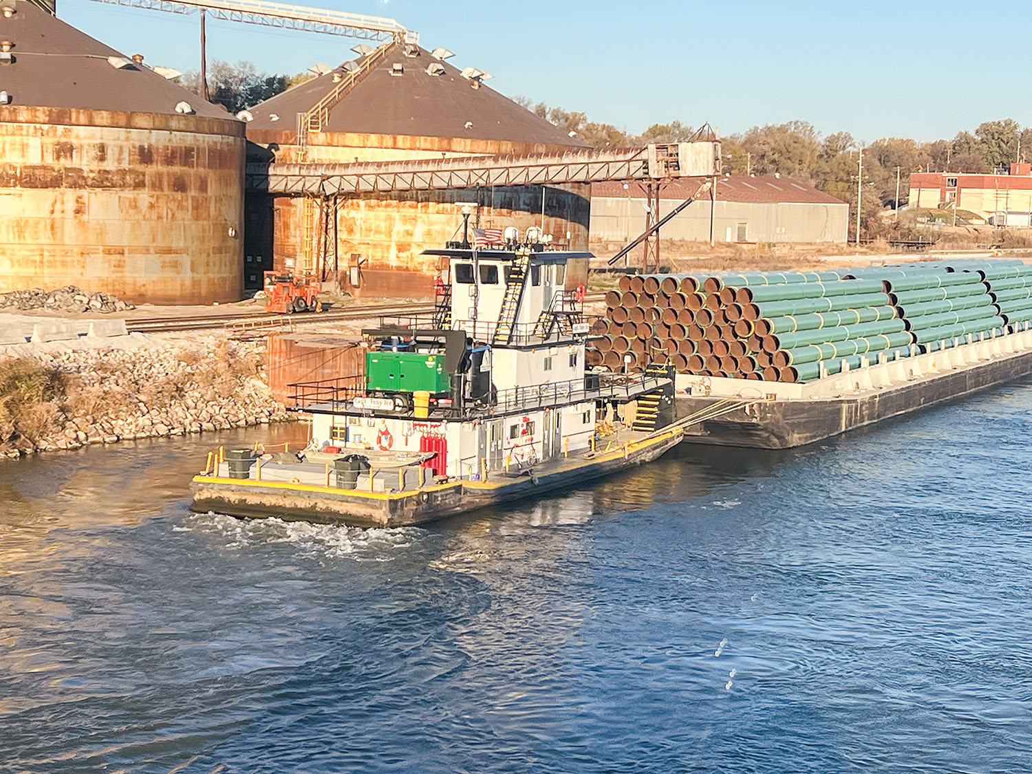 Tug pushing a loaded pipe barge on the Pearl River